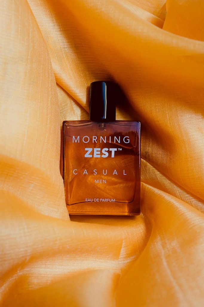 Elegant bottle of Morning Zest Mens Cologne on orange satin fabric. Perfect for lifestyle imagery.